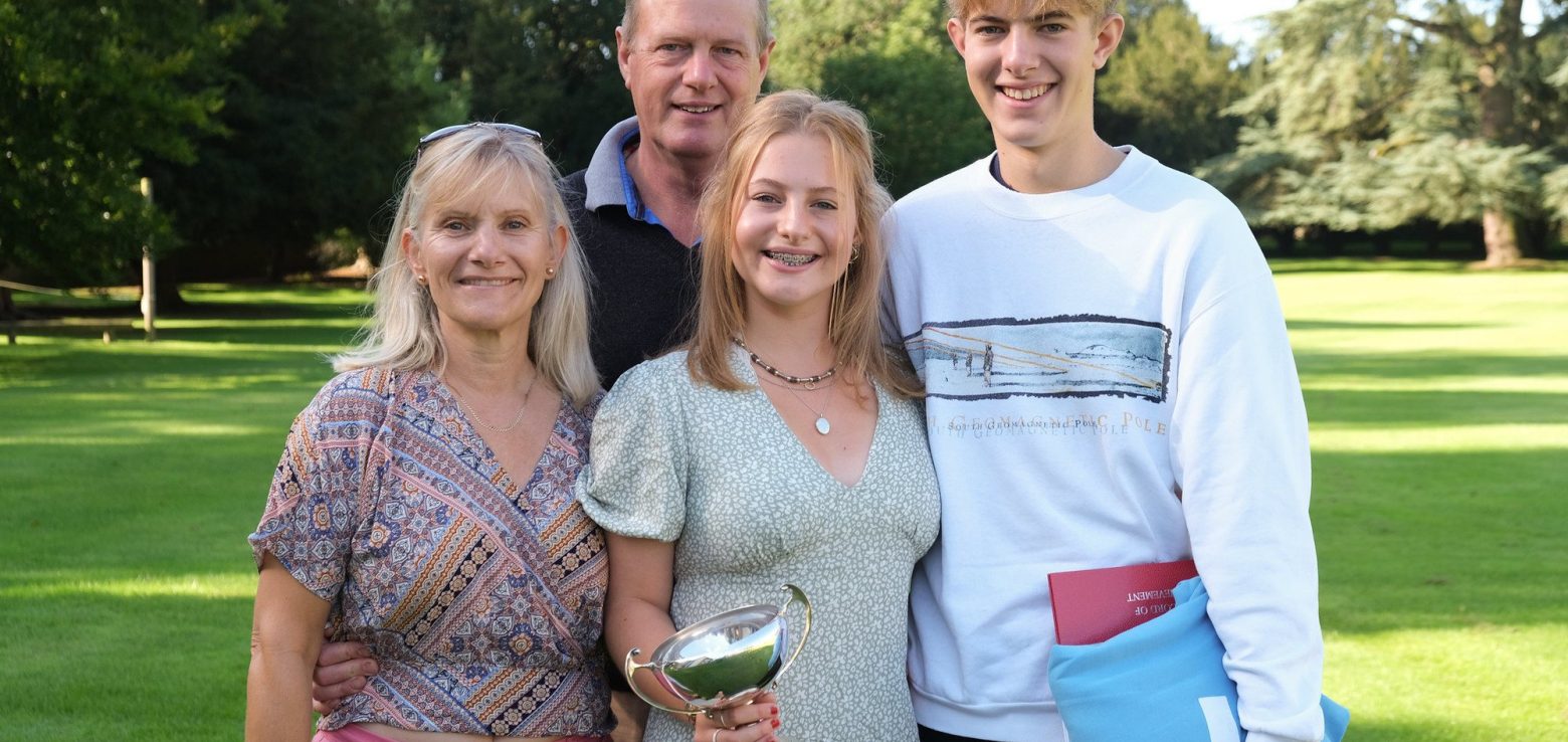 a family together celebrating a trophy win