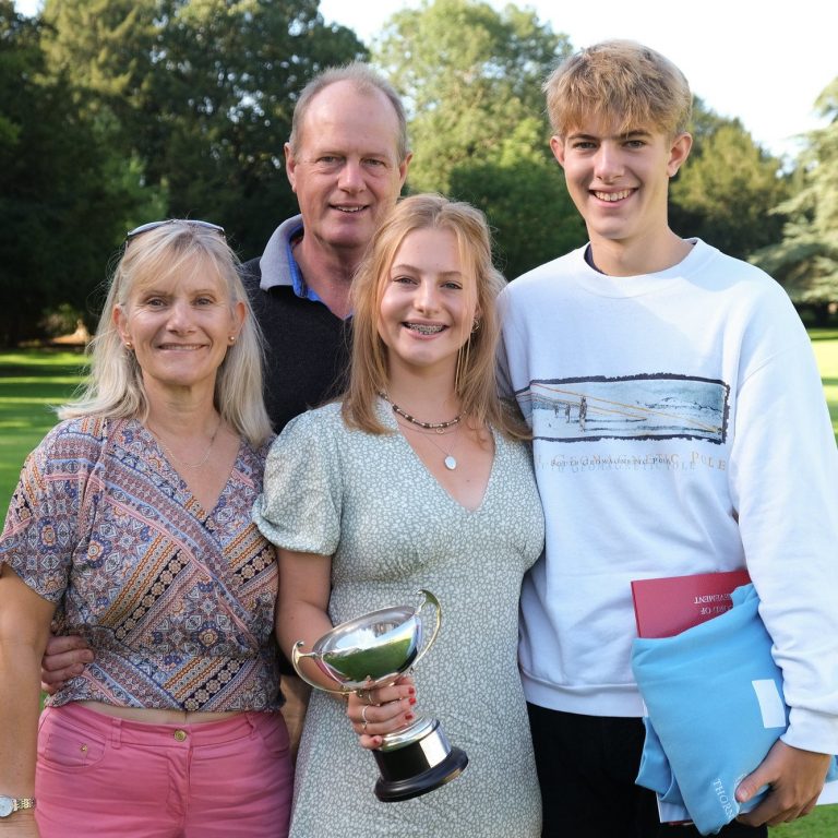 a family together celebrating a trophy win