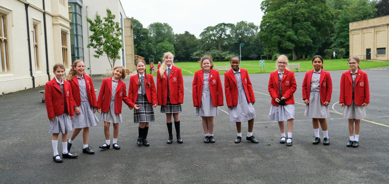 10 school girls in red blazers