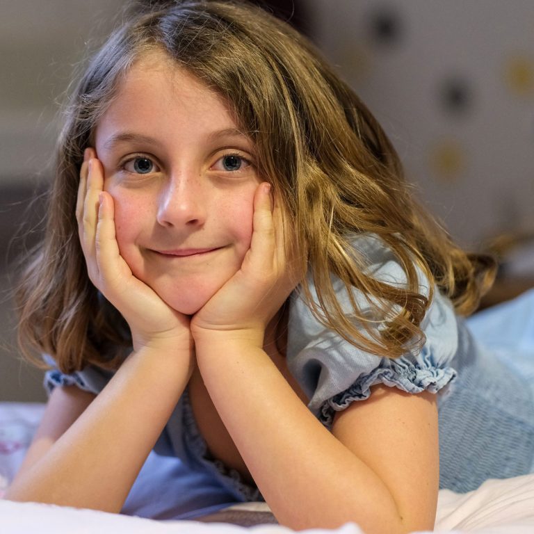 girl laying on her bed