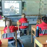 children watching a video in class