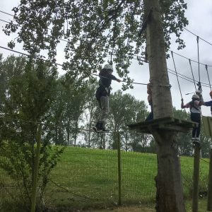 children crossing a rope bridge