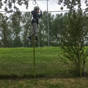 child crossing a rope bridge