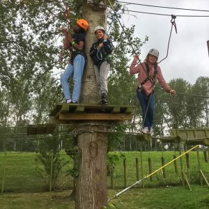 children completing a zip wire