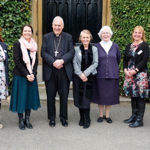 Bishop standing with teachers