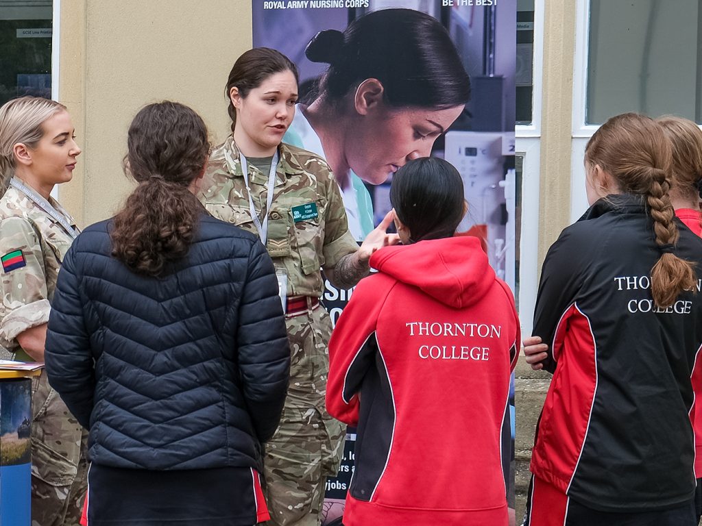 Army support staff talk to students