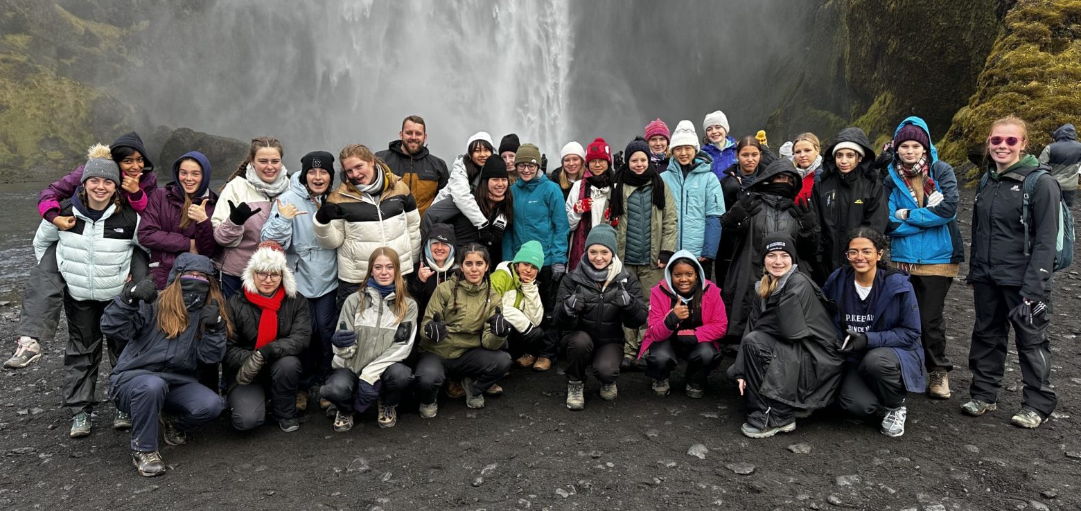 children in front a waterfall