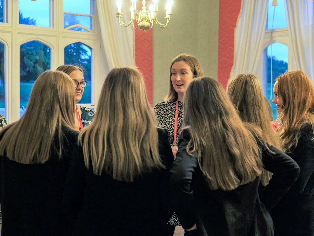 group of girls talking to a teacher