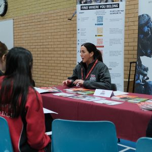 students talking to member of Army group