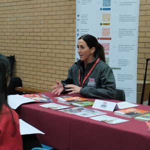 students talking to member of Army group