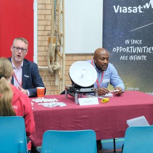 student talking to a man at a table