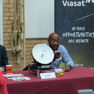 student talking to a man at a table