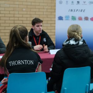 girl in Thornton uniform at a stand