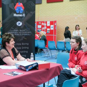 students in a group talking to staff