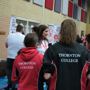 students in a group talking to staff