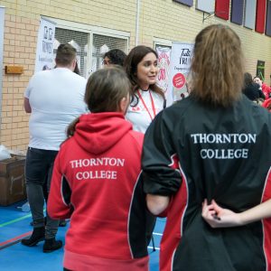 students in a group talking to staff