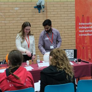 students in a group talking to staff