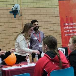 students in a group talking to staff