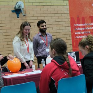 students in a group talking to staff