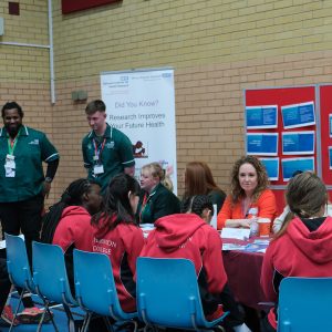 students in a group talking to staff