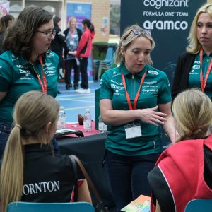 The Aston Martin team talking to students