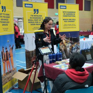 member of staff talking to students