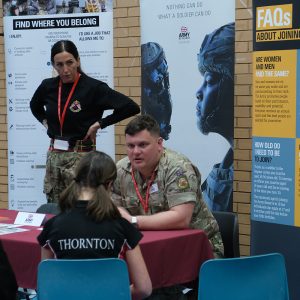 army talking to students