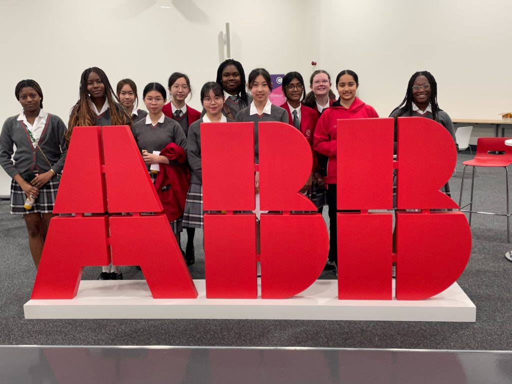 Girls stood in front of "ABB"