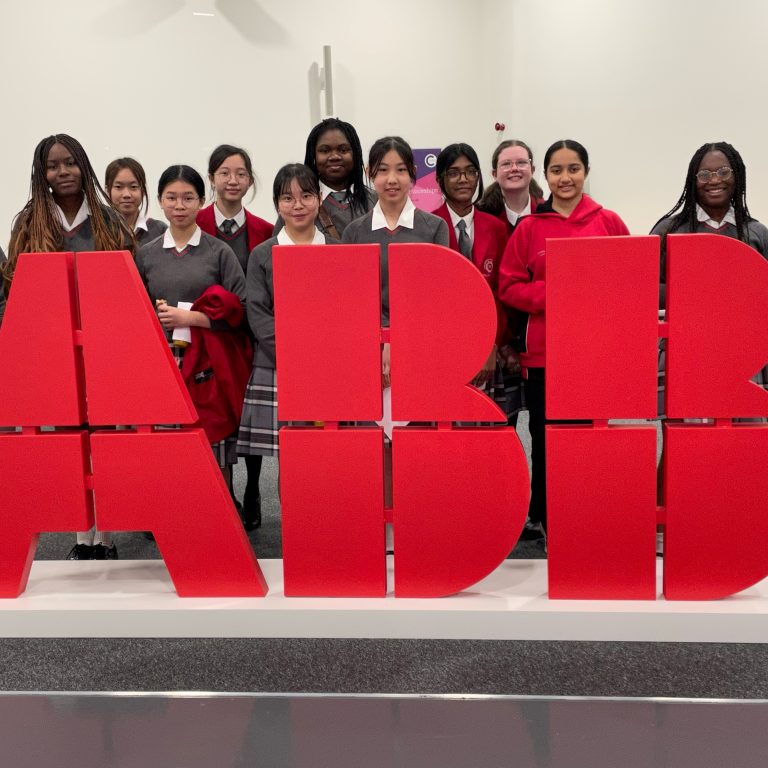 Girls stood in front of "ABB"