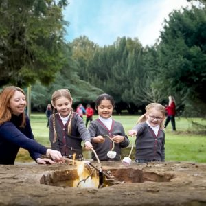 Children at the firepit with marshmallows