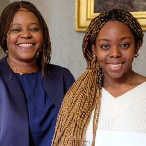 girl smiling by her mother