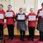 girls holding certificates