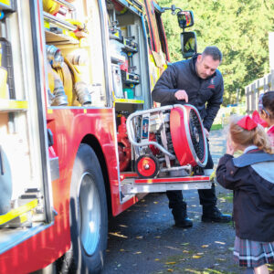 fireman showing children the fire engine