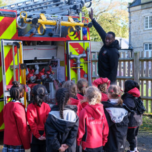 fireman showing students a ladder