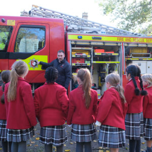 students looking at a fire engine