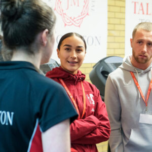 MK Dons Players In New Gym Talking With Sports Scholar Students