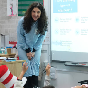 Lady smiling as she speaks to students