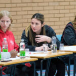 students debating at a desk