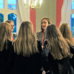 group of girls talking to a teacher