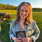 smiling girl holding a book