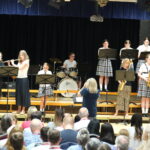 Group of students and teachers performing wind instruments